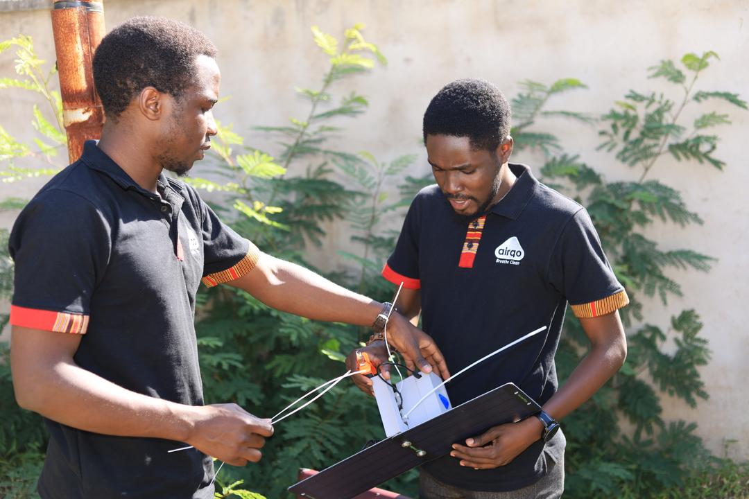 Two members in the field installing the monitor